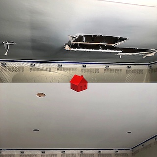 Ceiling drywall installation after water damage demo
