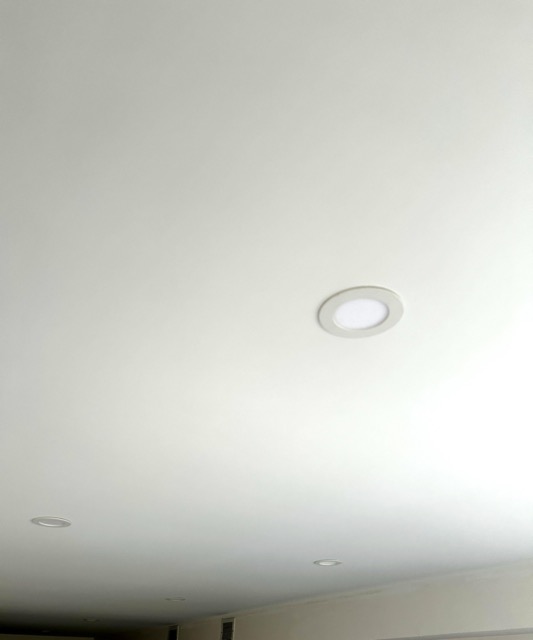 Smooth white ceiling finished around recessed lights